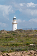 Fototapeta na wymiar Paphos, Paphos District, Cyprus - View over the historical lighthouse at the coast against blue sky