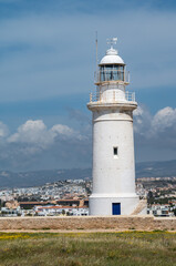 Fototapeta na wymiar Paphos, Paphos District, Cyprus - View over the historical lighthouse at the coast against blue sky