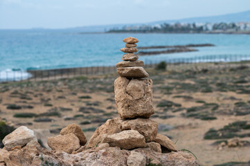 Fototapeta na wymiar Stacked pebble stones at the beach of Paphos, Cyprus