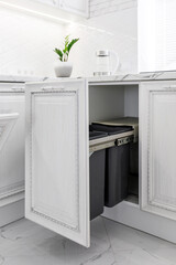 Option of furniture fittings for extending the trash can in a modern kitchen