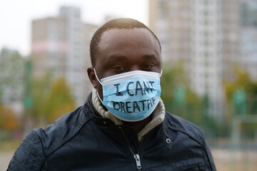 African american man activist in mask with an inscription I CANT BREATHE