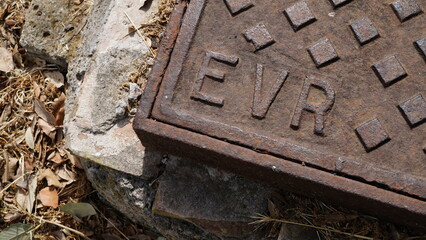 EUR written on cast iron manhole cover damaged by time