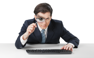 Businessman working and looking in magnifying glass