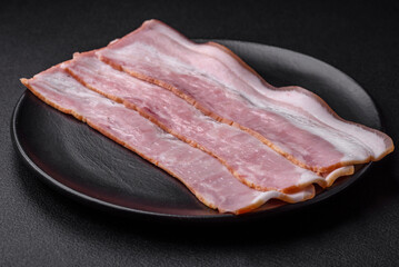 Delicious fresh bacon stripes with spices and salt