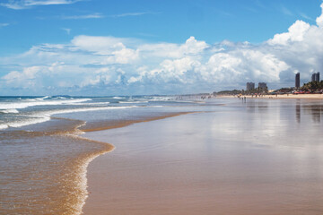 View of an Atlantic Ocean beach in the far north of Brazil. Futuro beach, Fortaleza, State of Ceara, Brazil. Sun, sea, sand, clouds and leasure. Tourism.