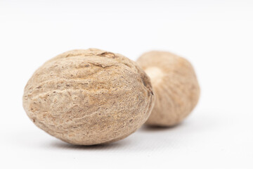Nutmeg isolated. Whole nut and nutmeg powder isolated on white background.