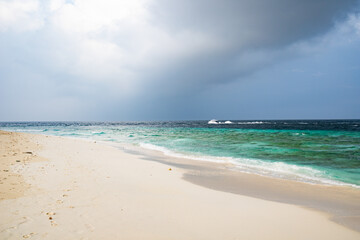 Fototapeta na wymiar beautiful exotic tropical beach and stormy clouds