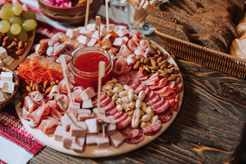 Snacks at the wedding, cheese, sausage, vegetables, meat products, Cossack table at the Ukrainian wedding.