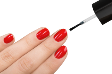 Beautiful manicure process. Nail polish being applied to hand, polish is a red color. White background closeup.