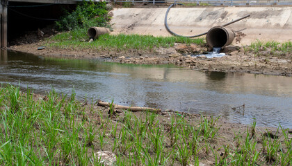 drain pipe or effluent or sewer release wastewater into river.