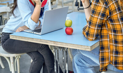 A couple with a notebook at the cafe table