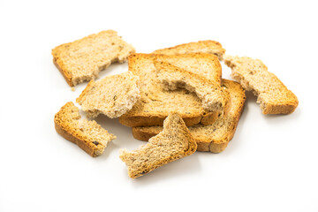 Crackers of dried rye bread, stacked on top of each other and broken, white background. Crunchy rusk or toast for healthy life