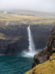 Múlafossur waterfall falling to the ocean