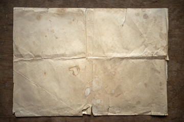 A vintage blank sheet of paper lies on a wooden table.Antique letterhead of crumpled paper.