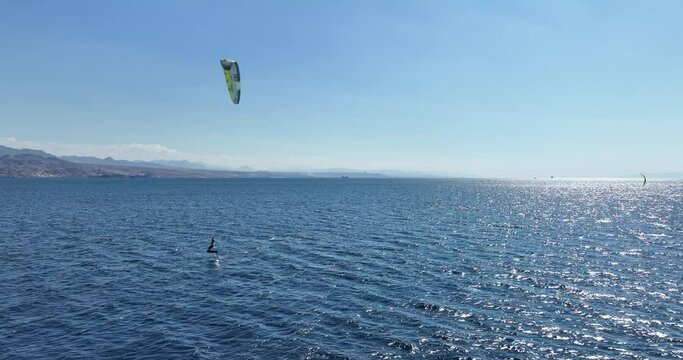 Aerial footage of professional kite surfers in front of the amazing beaches of Eilat.