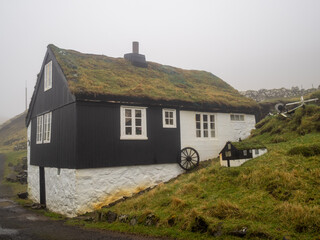 Fototapeta na wymiar Mykines turf roofed house with smaller model on the side