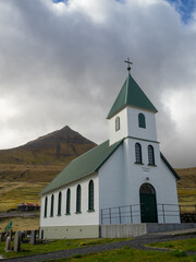Fototapeta na wymiar Gjógv church with Middagsfjall mountain in background