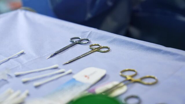 Surgical scissors, forceps and other materials for the operation. Medical tools on the special table. Close up.