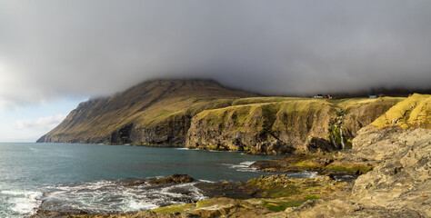 North Vidoy coastline in the sun below low clouds