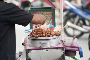 Street food originating from Indonesia is called pentol tofu grilled with spicy sauce. It has a nice and delicious taste