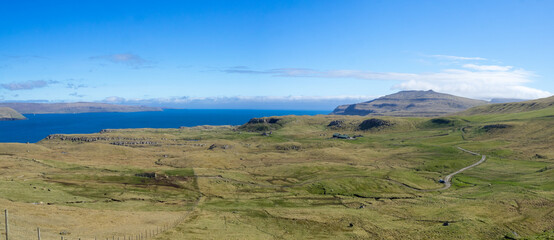 Grass fields of north Sandoy with Streymoy on the horizon