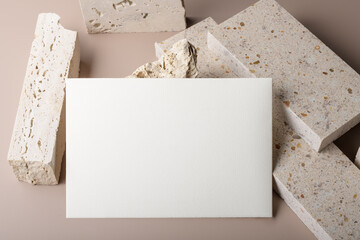 Wedding stationery invitation card mockup 7x5 on beige background and pieces of travertne marble stone. Bridal shower mockup. Minimal boho style blank mockup, thank you card, greeting card