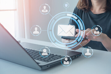 email marketing concept. Businessman sending email by smartphone and laptop computer. Online people...