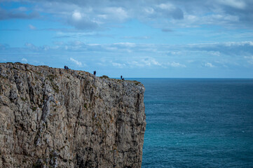 View of idyllic nature landscape with rocky cliff shore and waves crashing on. Rocks near Sagres....