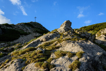 Fototapeta premium The Cross on top of the mountain against the blue sky.