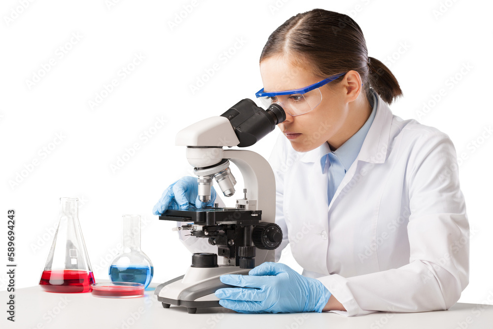 Wall mural Young scientist looking through a microscope in the laboratory.