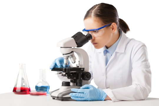 Young scientist looking through a microscope in the laboratory.