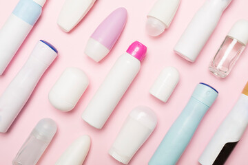 Many different deodorants on color background, top view