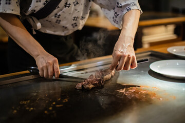 Tepanyaki - japanese grilled beef on pan. chef cooking at the hot table