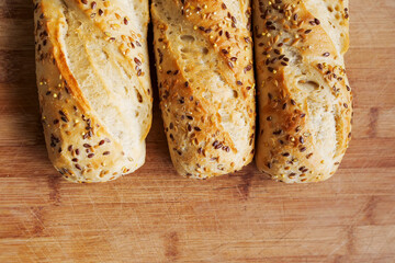 Panini rolls on a wooden board in a kitchen. Premium bread product with high quality and great taste. Healthy food.