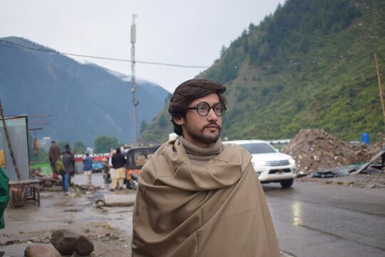 A young guy standing near road side at naran valley, Pakistan.