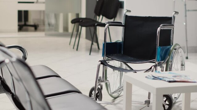 Wheelchair in empty diagnostic center used to cure disease and give prescription medicine. Hospital reception waiting room with seats and recovery equipment, disability friendly.