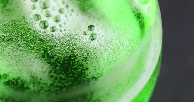 Green carbonated drink with gas on the table, green carbonated drink in a glass transparent glass