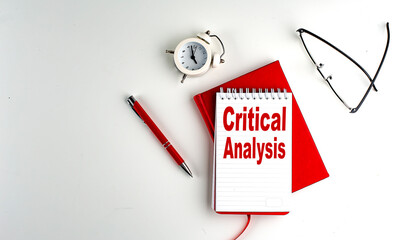 CRITICAL ANALYSIS text on notebook , red pen and notebook, business concept, white background
