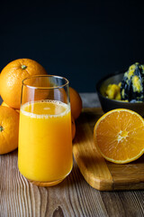 Glass of orange juice with oranges around