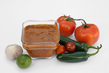 Delicious salsa sauce and ingredients on white background