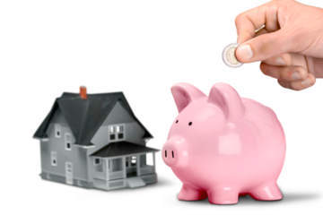 Businessman putting coin into the piggy bank isolated on white background