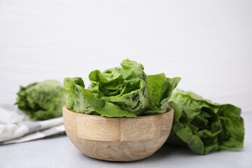 Fresh green romaine lettuces on grey table