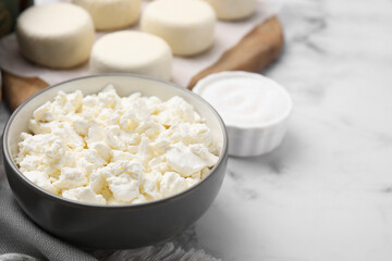 Bowl with dairy ingredient for cooking cottage cheese pancakes on white marble table, closeup and space for text