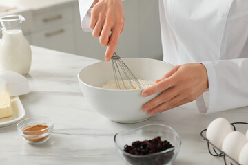 Professional chef making dough at white marble table indoors, closeup