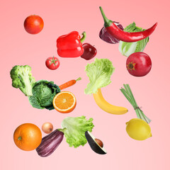 Many fresh vegetables and fruits falling on pale light red background