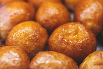 Close-up view of Loukoumades dessert, greek donuts with honey and walnut, traditional greek lokma...