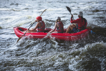 Raft boat during whitewater rafting extreme water sports on water rapids, kayaking and canoeing on...