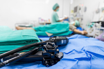 Medical colonoscopy or gastroscopy instrument on surgical table inside operating room in...