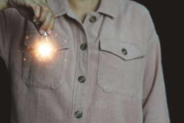 New concept with innovation and technology inspiration. Innovation in science and communication concepts, idea. Creativity. Thinking. Innovation. Hand holding a light bulb for ideas. 
