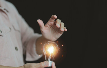 New concept with innovation and technology inspiration. Innovation in science and communication concepts, idea. Creativity. Thinking. Innovation. Hand holding a light bulb for ideas. 